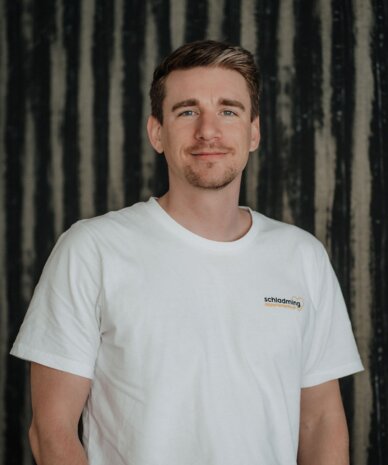 Portrait of a man in white T-shirt with Schladming logo