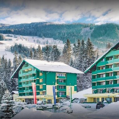Snowy mountain resort with green hotel buildings