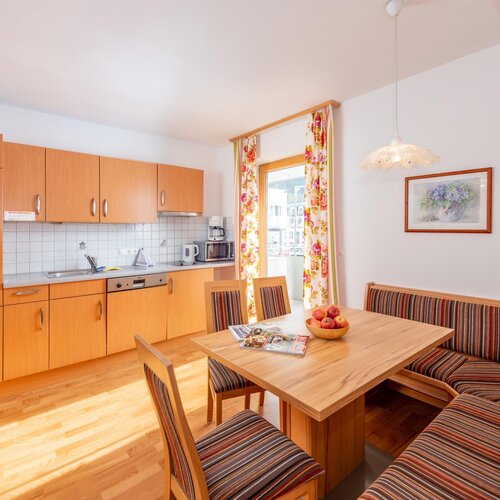 Heller Küchenbereich mit Holzschränken und Essbereich