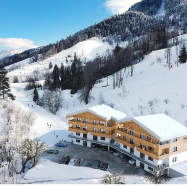 Snowy mountain lodge with wooden chalet buildings