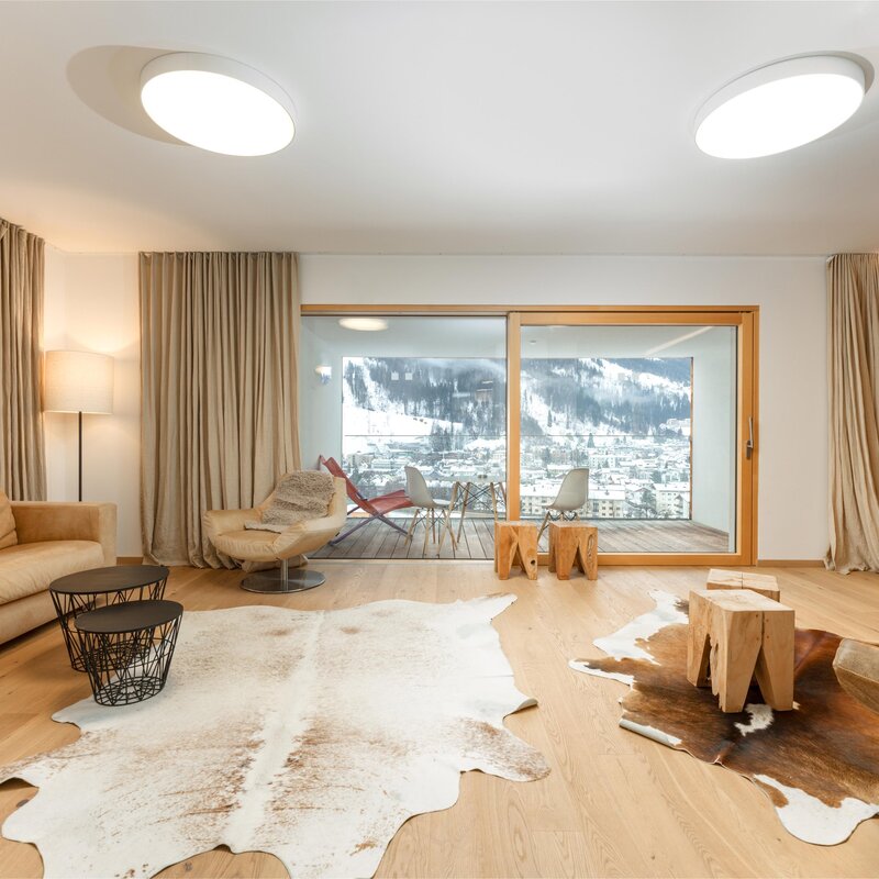 Bright living room with beige sofa and balcony view