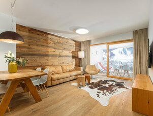 Modernes Wohnzimmer mit Holzvertäfelung, Ledersofa und Balkonblick